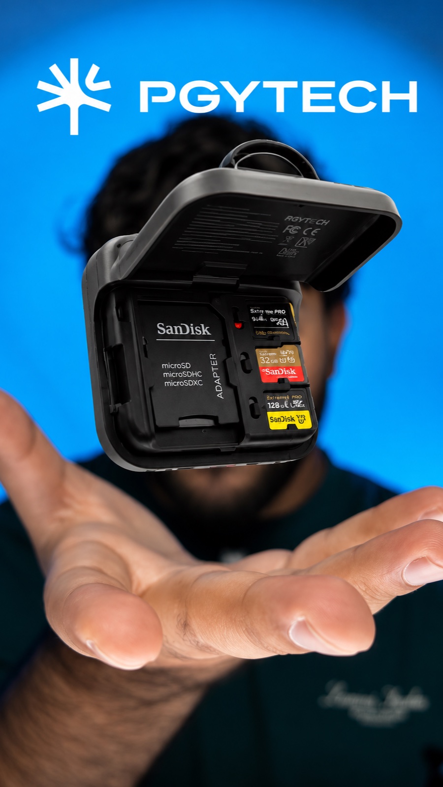 PGYTECH memory card case open in Saqib's palm, loaded with SanDisk cards